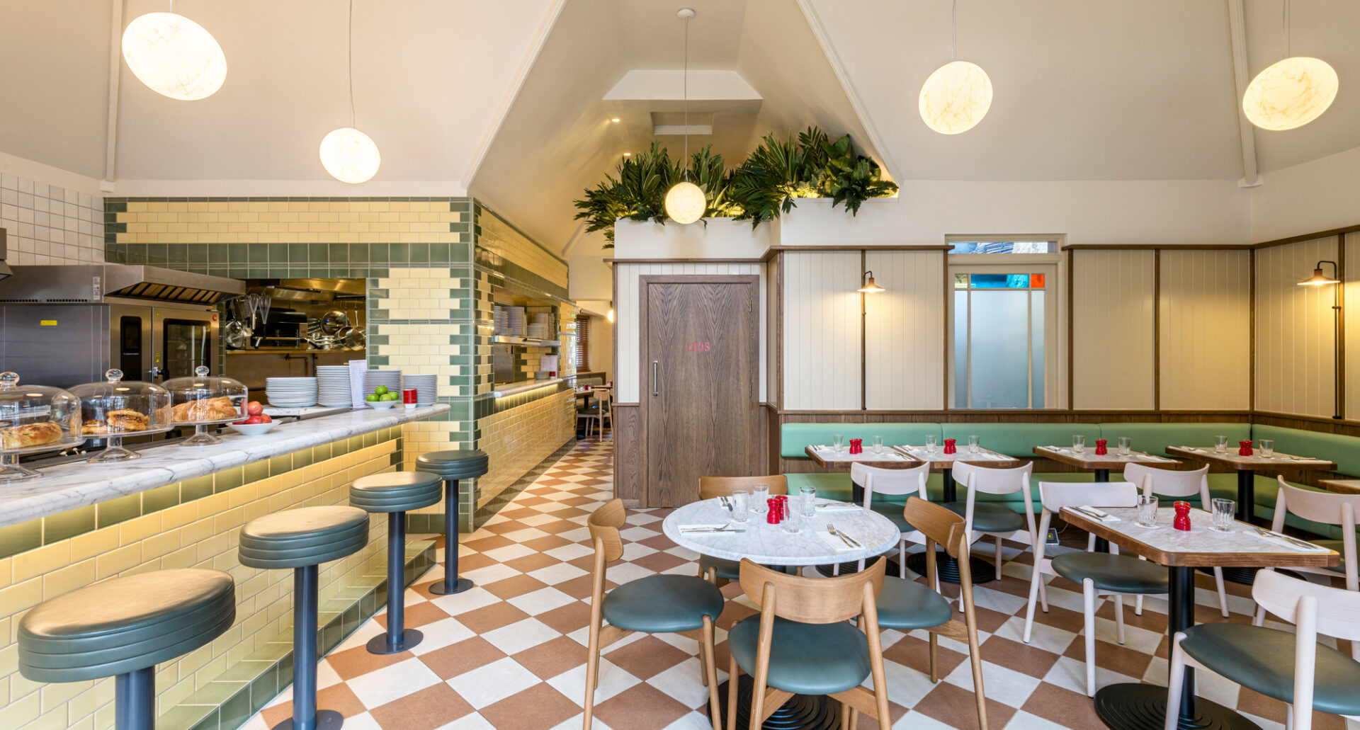 Audrey's Cafe & Bar Borough modern and retro restaurant designed by 3Stories Interior Design and branding creative agency London, featuring checkered floor, victorian inspired tiles, open kitchen and hanging lights, cosy and unpretencious interior