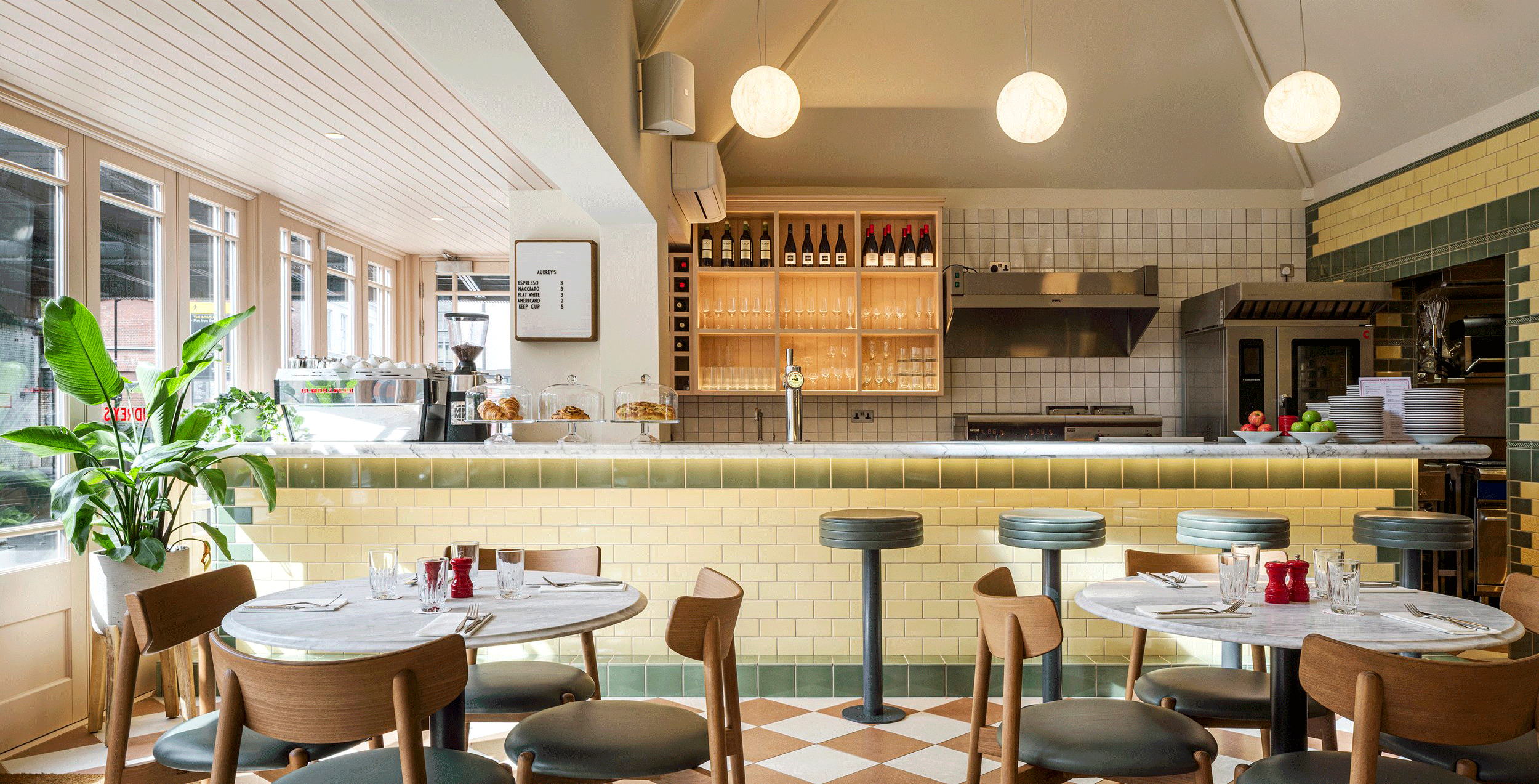 Audrey's Cafe & Bar Borough modern and retro restaurant designed by 3Stories Interior Design and branding creative agency London, featuring checkered floor, victorian inspired tiles, open kitchen and hanging lights, cosy and unpretencious interior