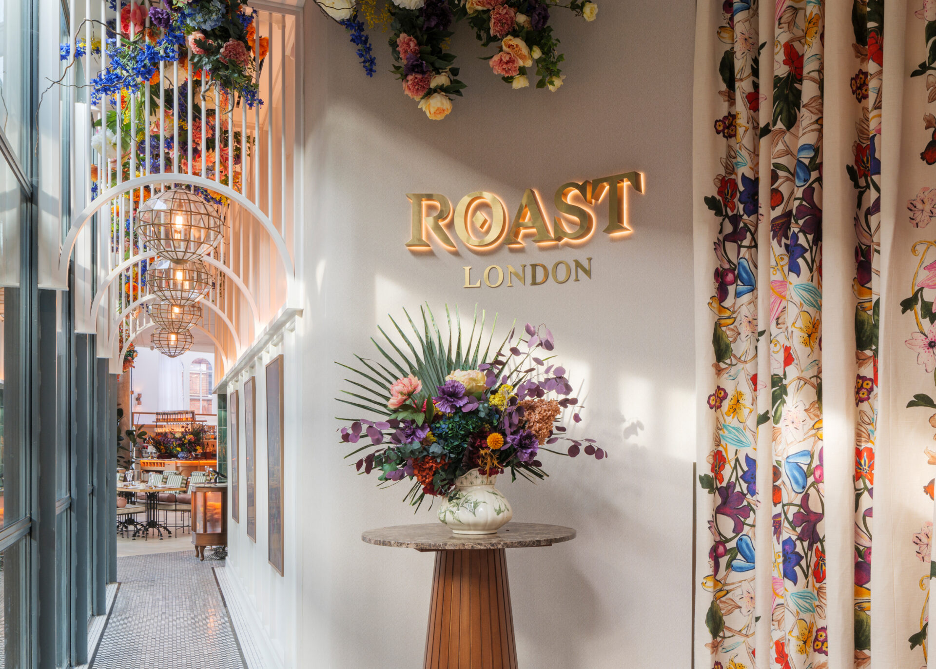Flower arrangement and logo feature at the entrance of Roast Restaurant London, designed by 3Stories brand and interior agency