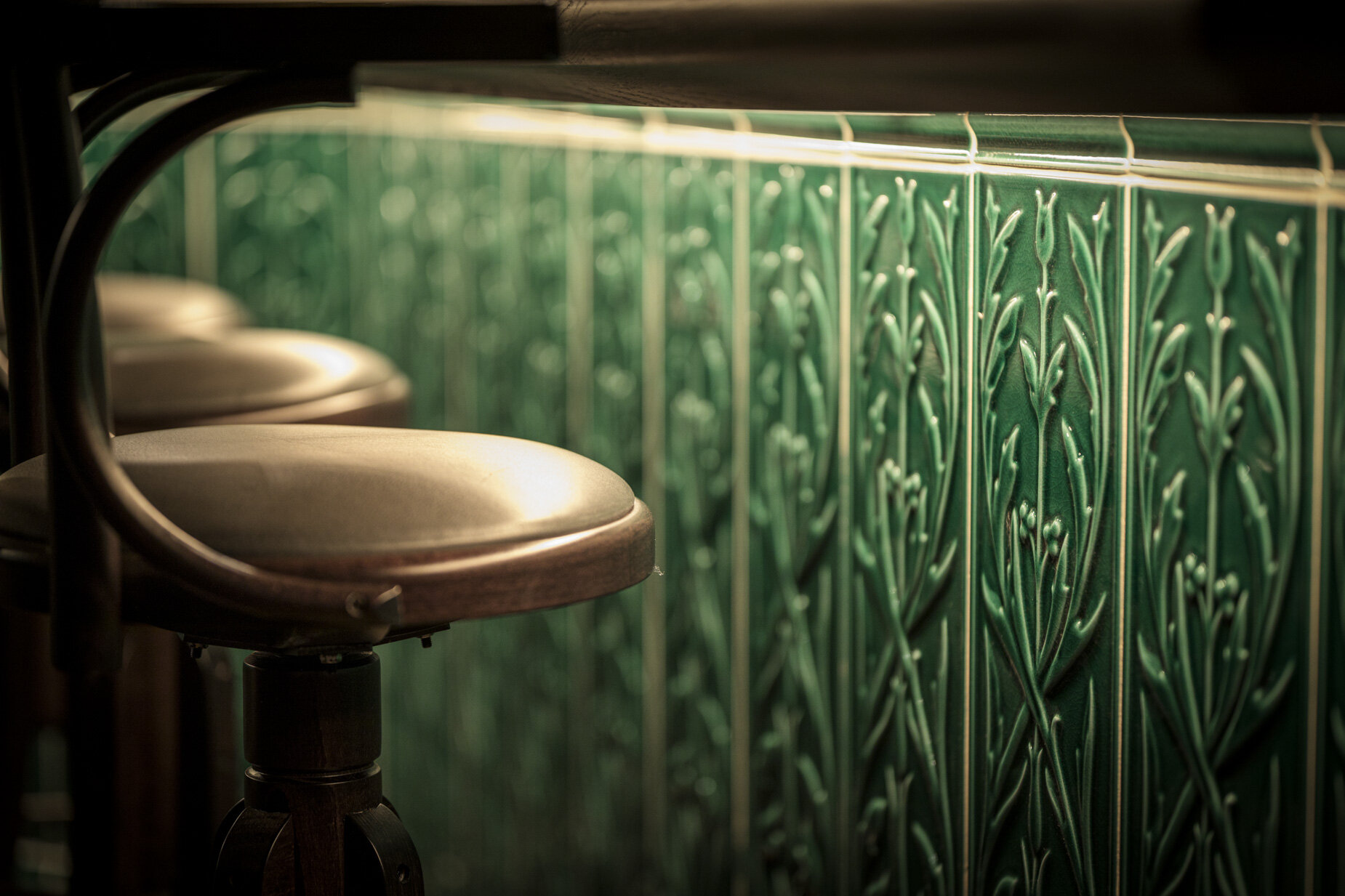Reclaimed green tiles bar detail and high seating