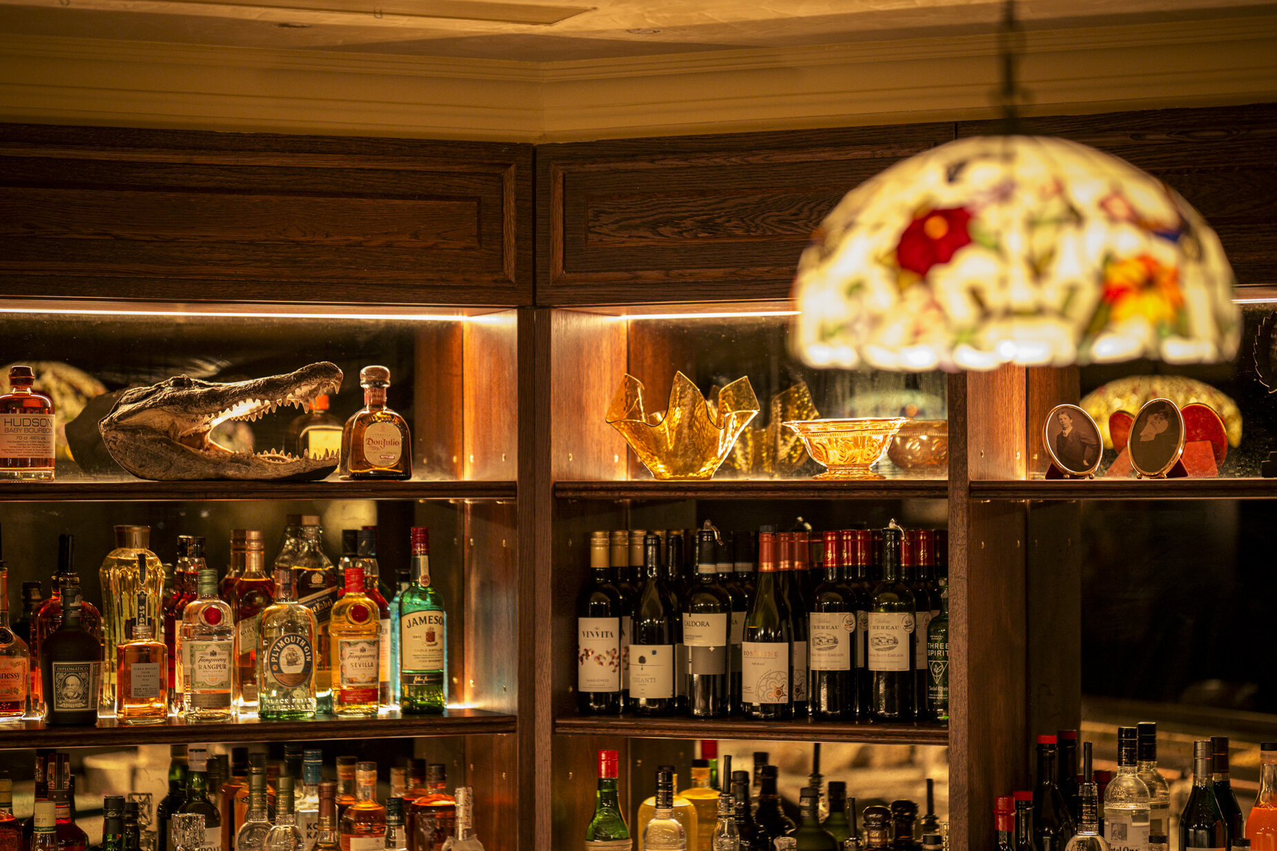 drinks shelf speakeasy bar, eclectic decor, alligator head