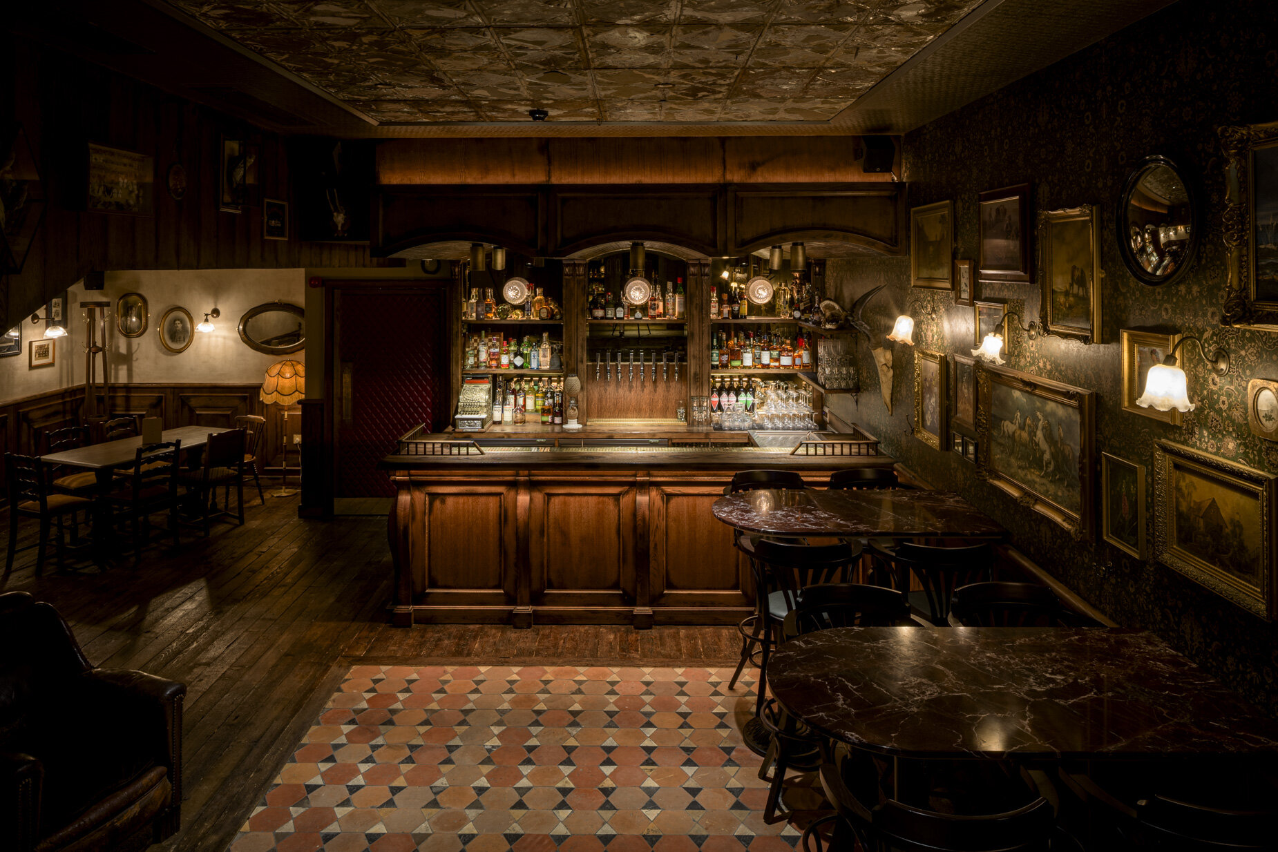 Moody, atmospheric, dim lit interior scene featuring authentic edwardian tiles, inside Good's Way music venue and events space in King's Cross, London, designed by 3Stories Interior Design and Branding creative agency.