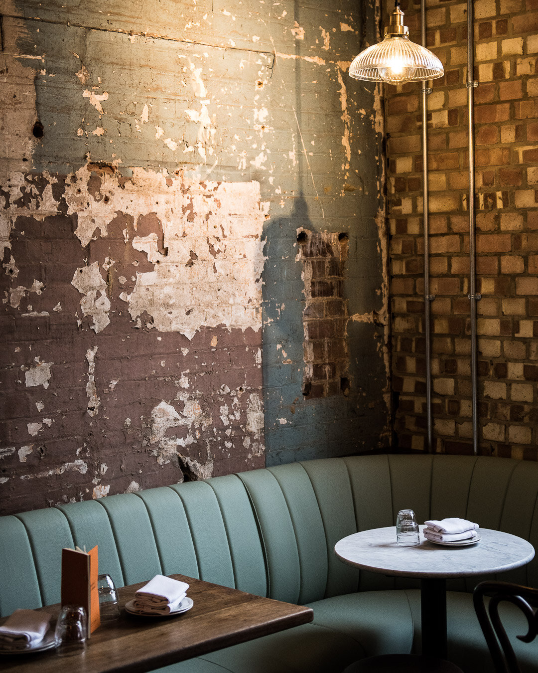 banquette seating and dining, featuring edwardian brick wall, worn out look, interior design made by 3Stories