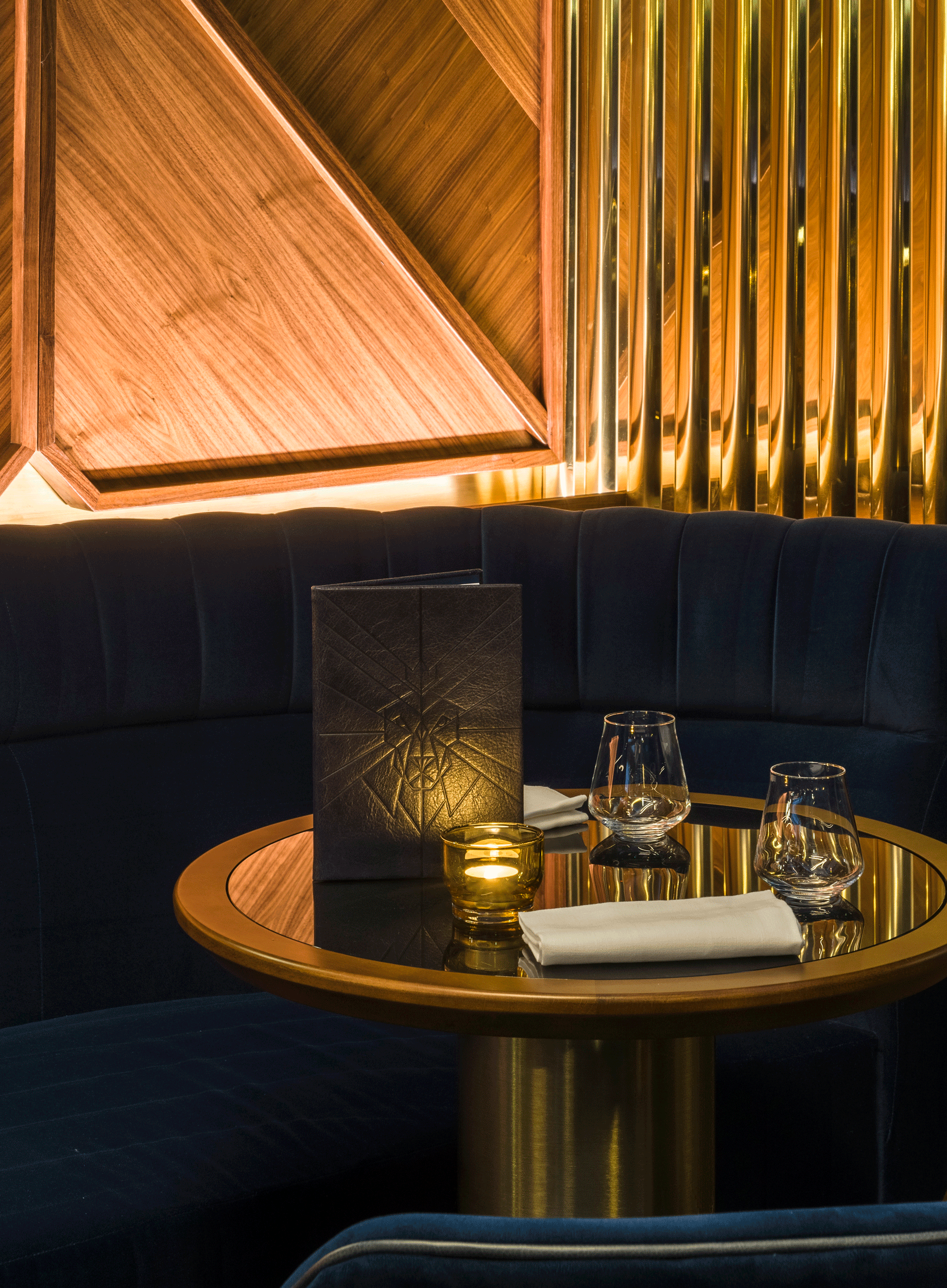 Atmospheric restaurant interior scene with a menu on a table, featuring a geometric logo of a lion, art deco inspired inside of The Court Member's Club London