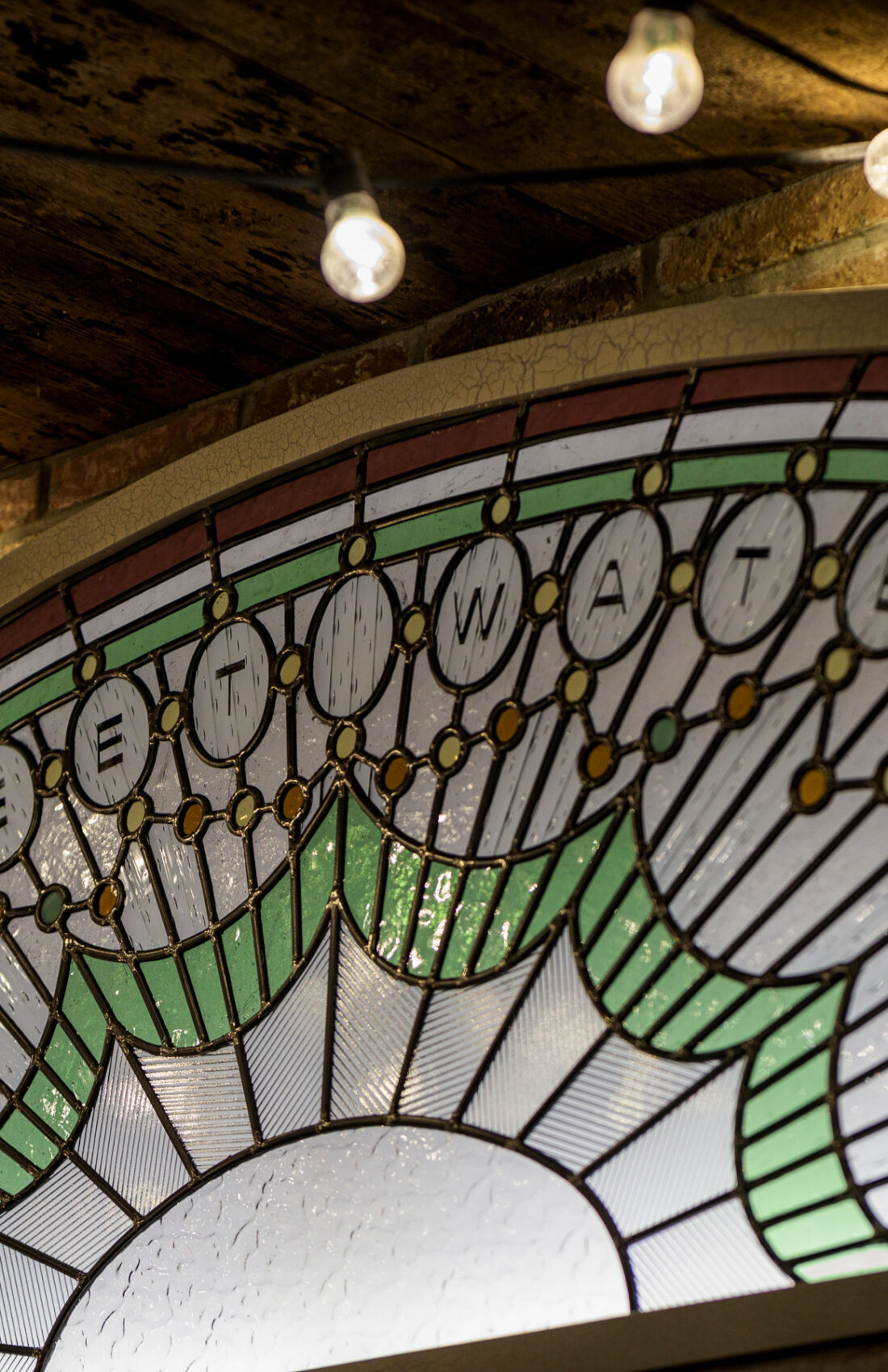Detail of retro reclaimed Stained Glass, Sweet Water in Goods Way music venue and events space in London Kings Cross, London, designed by 3Stories Interior Design and Branding creative agency.