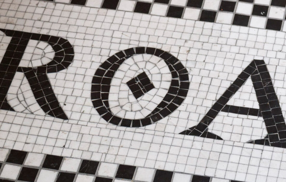 Detail of mosaic decorative black and white tiles, victorian inspired, featuring a fragment of a geometric logo of Roast Restaurant in Borough Market, designed by 3Stories Interior Design and Branding creative agency